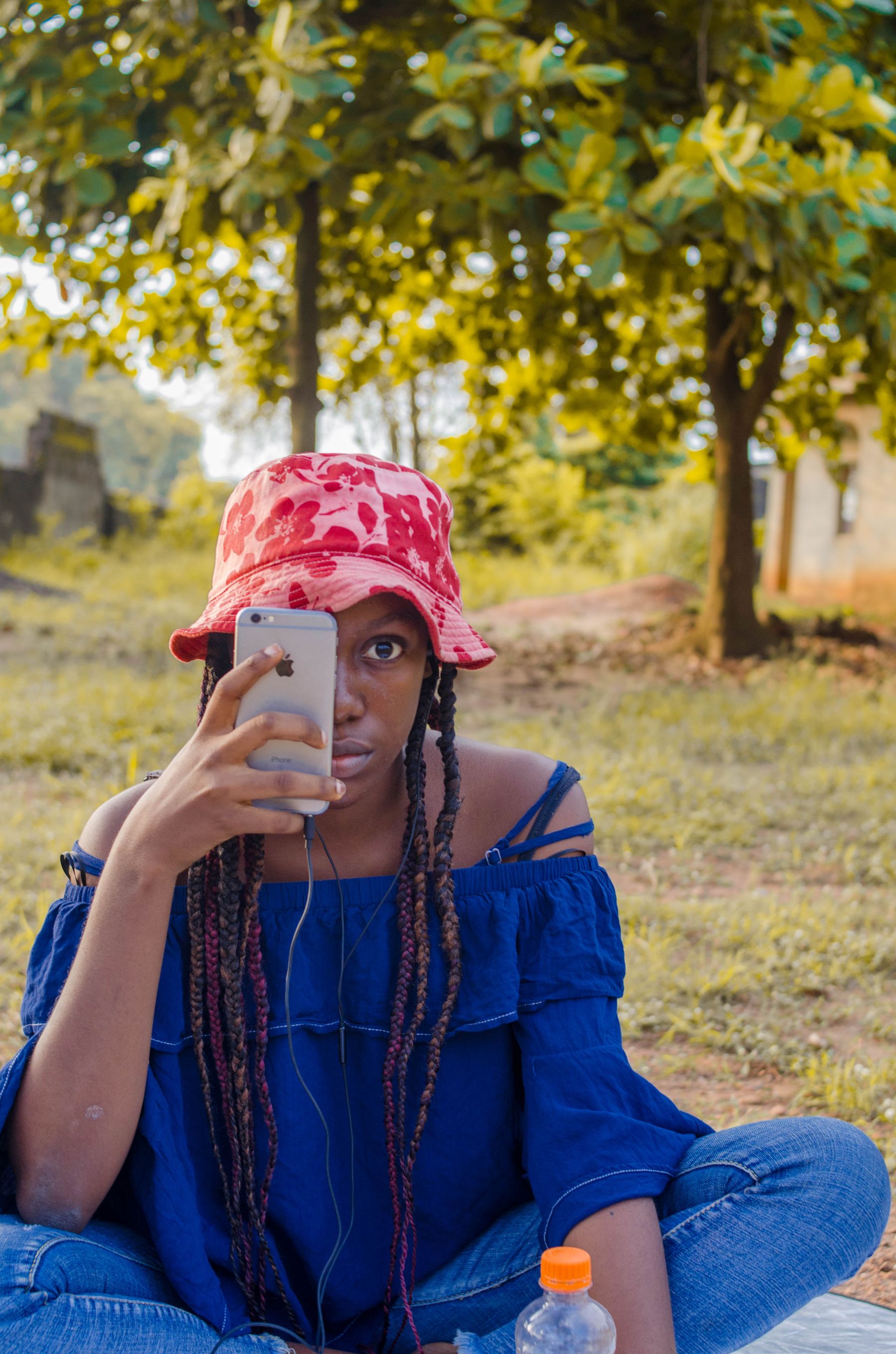 Nigerian woman using her phone in a Lagos park