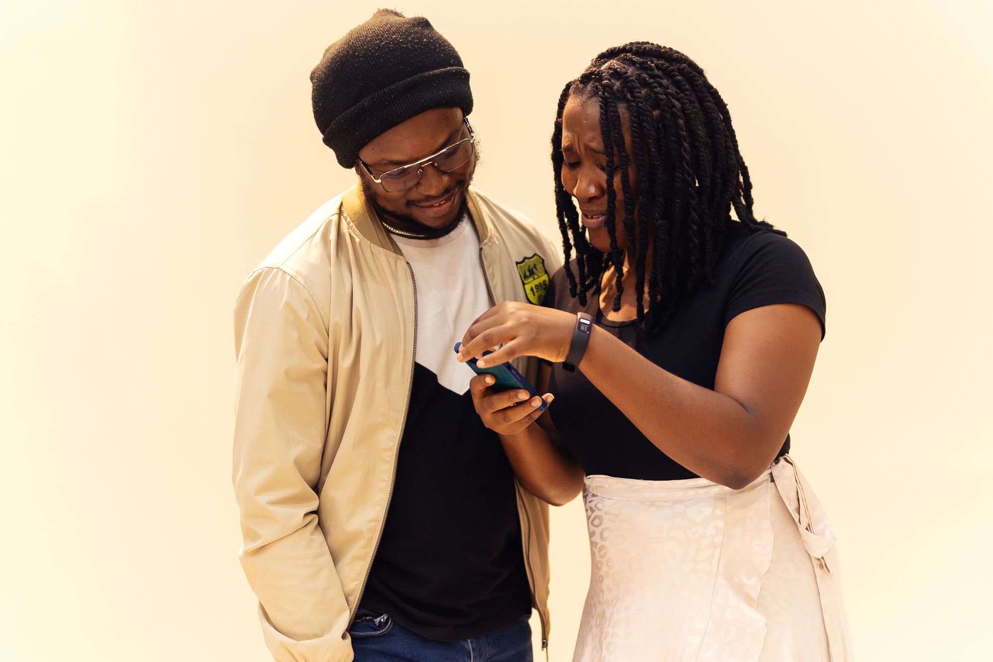 Two Nigerians checking a smartphone in Lagos